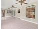 Spacious living room featuring tile floors, multiple windows, and three ceiling fans at 1015 Hastings Ct, Lutz, FL 33548