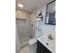 Modern bathroom with a tiled walk-in shower, vanity, and stylish fixtures at 1028 E 93Rd Ave # A, Tampa, FL 33612