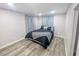 Cozy bedroom with soft lighting, plush bedding and new flooring at 1028 E 93Rd Ave # A, Tampa, FL 33612