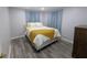 Comfortable bedroom with soft lighting, plush bedding and new flooring at 1028 E 93Rd Ave # A, Tampa, FL 33612