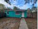 Charming one-story home with a teal exterior and a welcoming front entrance with walkway at 1028 E 93Rd Ave # A, Tampa, FL 33612