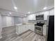 Modern kitchen with stainless appliances, granite countertops, and sleek white cabinets at 1028 E 93Rd Ave # A, Tampa, FL 33612