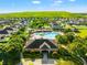 Community aerial view featuring pool and clubhouse, surrounded by lush landscaping and residential homes at 10909 Kirkwall Port Dr, Wimauma, FL 33598