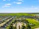 Community aerial view with a large amenity center, pool, and ample green spaces for recreation at 10909 Kirkwall Port Dr, Wimauma, FL 33598