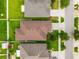 Aerial view of the home showing the roof, landscaping, and proximity to neighboring properties at 10909 Kirkwall Port Dr, Wimauma, FL 33598