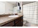 Bathroom features a vanity with dark wood cabinets, a white sink, and a shower with a curtain at 10909 Kirkwall Port Dr, Wimauma, FL 33598
