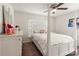 Bright bedroom featuring a four-poster bed, neutral walls, and ample natural light at 10909 Kirkwall Port Dr, Wimauma, FL 33598