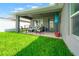 Inviting covered patio with comfortable seating, perfect for enjoying the outdoors in style at 10909 Kirkwall Port Dr, Wimauma, FL 33598