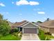 Charming single-story home featuring a well-maintained lawn and a two-car garage at 10909 Kirkwall Port Dr, Wimauma, FL 33598