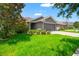 Well-manicured lawn complements this single-story home featuring an attached two-car garage at 10909 Kirkwall Port Dr, Wimauma, FL 33598