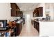Well-equipped kitchen with stainless steel appliances, dark cabinetry, and granite countertops at 10909 Kirkwall Port Dr, Wimauma, FL 33598