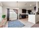 Open kitchen and dining area with dark cabinetry, tile flooring, and natural light at 10909 Kirkwall Port Dr, Wimauma, FL 33598