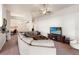 Bright living room with large sectional sofa, entertainment center, and view to study at 10909 Kirkwall Port Dr, Wimauma, FL 33598