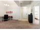 Open living area with neutral paint, carpet flooring, and front door view at 10909 Kirkwall Port Dr, Wimauma, FL 33598
