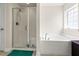 Bright main bathroom featuring a soaking tub, separate shower, and tile flooring at 10909 Kirkwall Port Dr, Wimauma, FL 33598