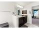 Lovely main bathroom with dual sinks, granite countertops, and an open doorway at 10909 Kirkwall Port Dr, Wimauma, FL 33598
