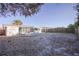 Wide view of backyard featuring a partially covered patio, fence line, and storage shed at 1131 Dartmouth Dr, Holiday, FL 34691