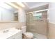 Updated bathroom featuring a glass-enclosed shower, modern fixtures, and neutral color scheme at 1131 Dartmouth Dr, Holiday, FL 34691