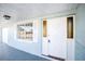 Inviting front porch features a white door with decorative glass panels, plus a window and white shutters at 1131 Dartmouth Dr, Holiday, FL 34691