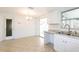 Updated kitchen features white cabinets, granite counters, tile backsplash and stainless-steel appliances at 1131 Dartmouth Dr, Holiday, FL 34691