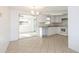 Bright kitchen with white cabinets, countertops, and modern appliances; dining area with slider at 1131 Dartmouth Dr, Holiday, FL 34691