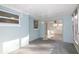 Covered patio with painted walls, concrete floor, and access to the sunroom via sliding glass doors at 1131 Dartmouth Dr, Holiday, FL 34691