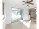 Bright sunroom featuring tile flooring, multiple windows, and direct access to the kitchen at 1131 Dartmouth Dr, Holiday, FL 34691