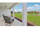 Covered back porch featuring comfortable seating and serene pond views at 12004 Cinnamon Fern Dr, Riverview, FL 33579