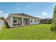 The backyard with a covered porch, a lush lawn, and space for outdoor activities at 12004 Cinnamon Fern Dr, Riverview, FL 33579