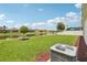 Landscaped backyard with a pond view, a lush lawn, and space for outdoor recreation at 12004 Cinnamon Fern Dr, Riverview, FL 33579