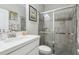 Bathroom featuring a white vanity, toilet, and glass-enclosed shower with tiled walls and floor at 12004 Cinnamon Fern Dr, Riverview, FL 33579