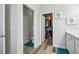 Bathroom featuring double doors to closet and toilet with wood-look floors and blue accents at 12004 Cinnamon Fern Dr, Riverview, FL 33579
