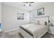 Bedroom with a white bed frame, patterned bedding, neutral walls, carpeted floor, and a ceiling fan at 12004 Cinnamon Fern Dr, Riverview, FL 33579
