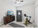 Bedroom setup as gym with exercise bike, personal sauna, TV, dresser, and gray carpet at 12004 Cinnamon Fern Dr, Riverview, FL 33579