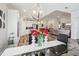 Modern dining area featuring a glass table, contemporary lighting, and open flow to the kitchen at 12004 Cinnamon Fern Dr, Riverview, FL 33579