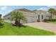 Stunning single-story home with a three-car garage, lush lawn and beautiful landscaping at 12004 Cinnamon Fern Dr, Riverview, FL 33579