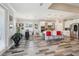 Open kitchen featuring white cabinets, stainless steel appliances, island with seating, and dining area at 12004 Cinnamon Fern Dr, Riverview, FL 33579