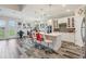 Bright, open kitchen with white cabinets, large island, and stainless steel appliances at 12004 Cinnamon Fern Dr, Riverview, FL 33579