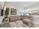 Spacious living room connected to the kitchen, featuring a large sectional sofa and modern decor at 12004 Cinnamon Fern Dr, Riverview, FL 33579