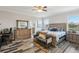 Spacious main bedroom suite with natural light, a king-sized bed, and tiled floor at 12004 Cinnamon Fern Dr, Riverview, FL 33579