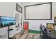 Spacious office featuring a projector screen, a desk, and hardwood floors at 12004 Cinnamon Fern Dr, Riverview, FL 33579
