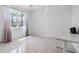 Bright, naturally lit bedroom with tile flooring, white walls, and a large window with sheer curtains at 12739 Rainwashed Loop, Parrish, FL 34219