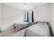 Bedroom with two twin beds, tile floors, and a window for natural light at 12739 Rainwashed Loop, Parrish, FL 34219