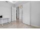 Bright and airy bedroom with white walls, tile floor, and a view into a hallway with closet and doorway at 12739 Rainwashed Loop, Parrish, FL 34219