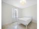 Bright bedroom featuring a modern light fixture, neutral walls and tile flooring at 12739 Rainwashed Loop, Parrish, FL 34219