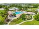 Aerial view of the community pool, playground, and lounging area surrounded by lush greenery at 12739 Rainwashed Loop, Parrish, FL 34219
