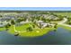 Aerial view of community amenities including a pool, playground, and lakeside amphitheater at 12739 Rainwashed Loop, Parrish, FL 34219