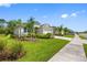 Charming home with a manicured lawn and landscaping along with a paved driveway and sidewalk at 12739 Rainwashed Loop, Parrish, FL 34219