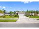 A single-Gathering home featuring a well-manicured lawn, colorful landscaping, and a two-car garage at 12739 Rainwashed Loop, Parrish, FL 34219