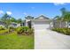 Beautiful home with a well-manicured lawn, lovely landscaping, and a spacious two-car garage at 12739 Rainwashed Loop, Parrish, FL 34219